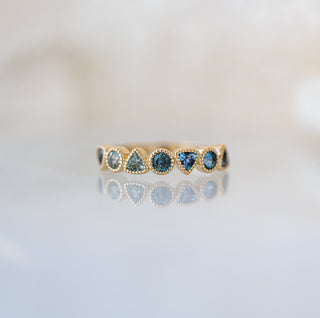 Trilliant and Round Teal Sapphire Band